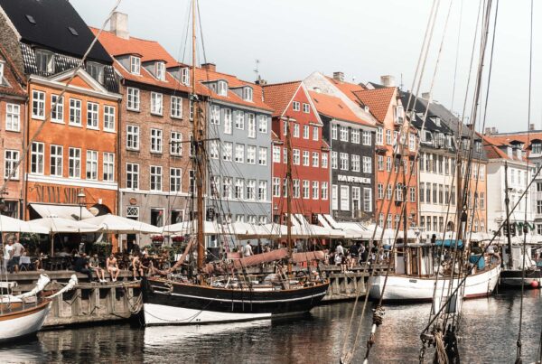 Nyhavn, a colorful harbor with historic buildings, houseboats, and restaurants in Copenhagen, Denmark.
