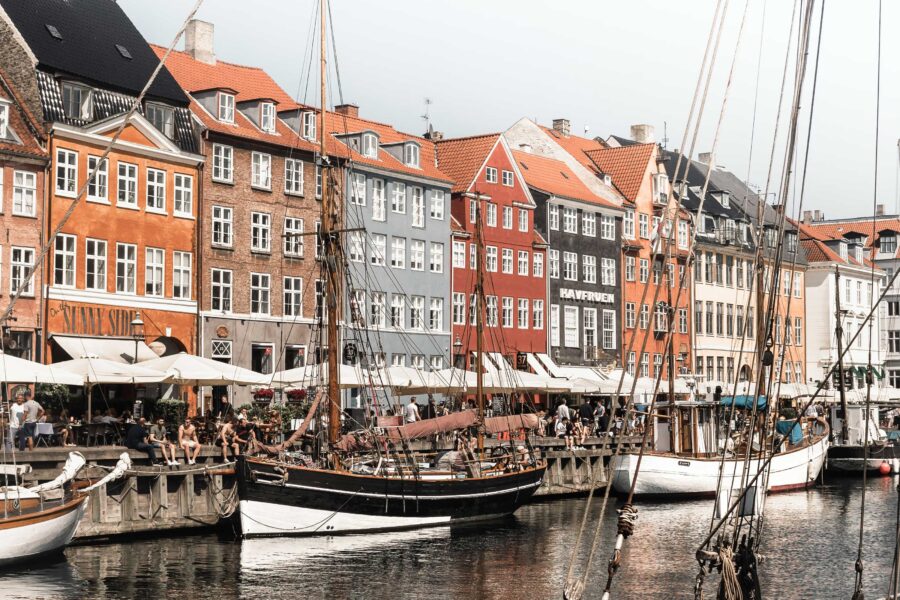 Nyhavn, a colorful harbor with historic buildings, houseboats, and restaurants in Copenhagen, Denmark.