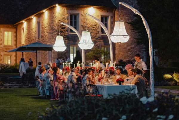 Guests in 17th-century attire enjoying the grand dinner at the Dominique Crenn Experience (fairytale setting).