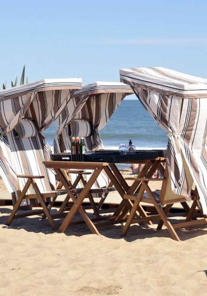 Beach chairs on a sandy shore overlooking the ocean in Uruguay. Satopia Travel