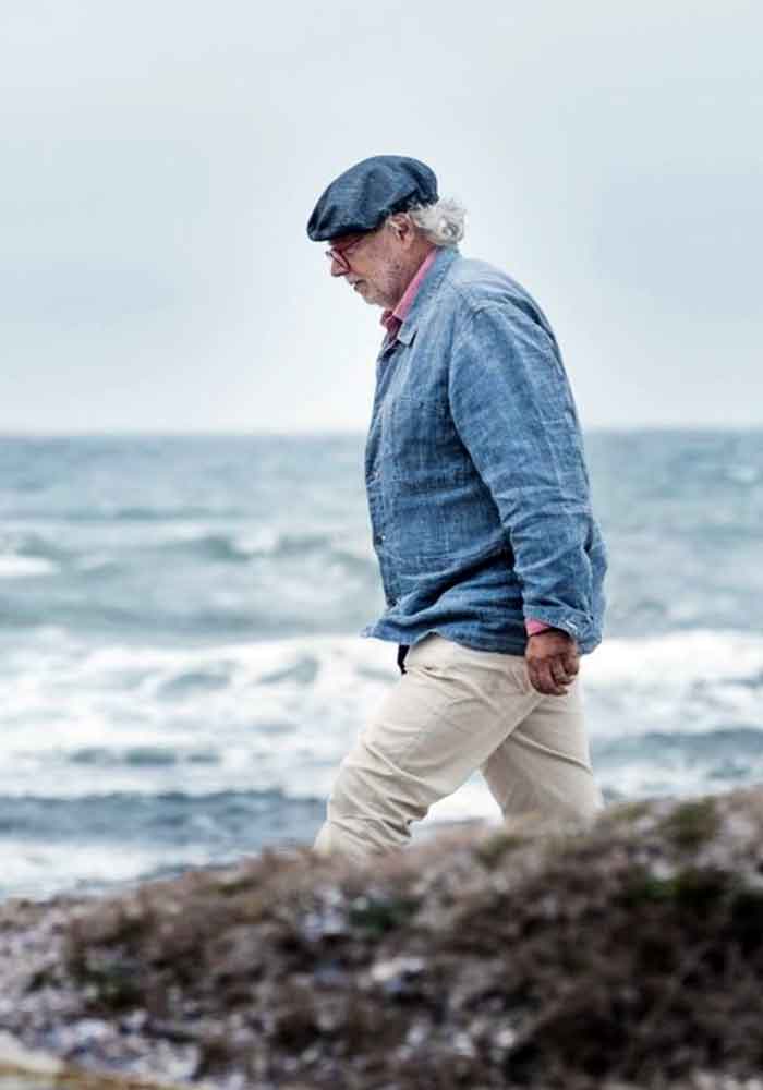Chef Francis Mallmann walks a scenic Uruguayan beach.